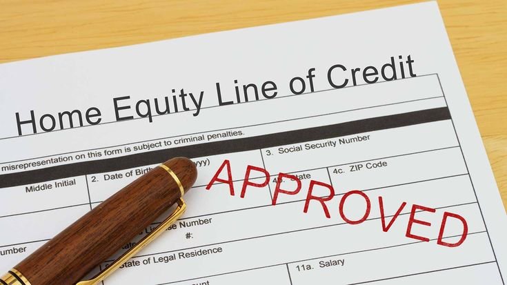 Homeowner reviewing documents and renovation plans with a contractor, symbolizing financing a home remodel through a HELOC.( how to finance home renovations