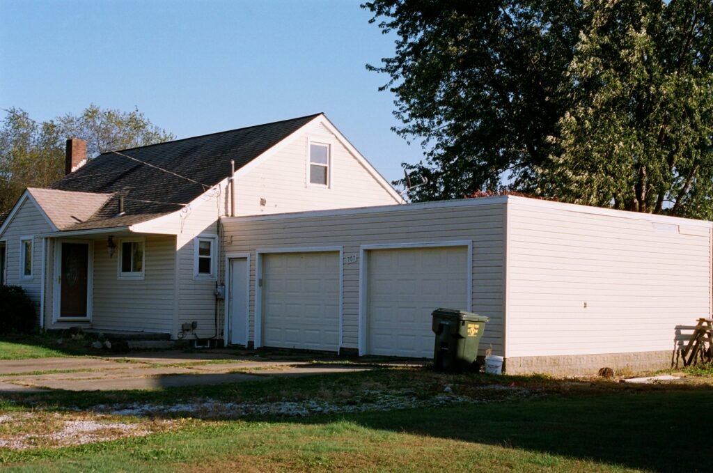 Partially rebuilt garage structure during winter with snowy surroundings.