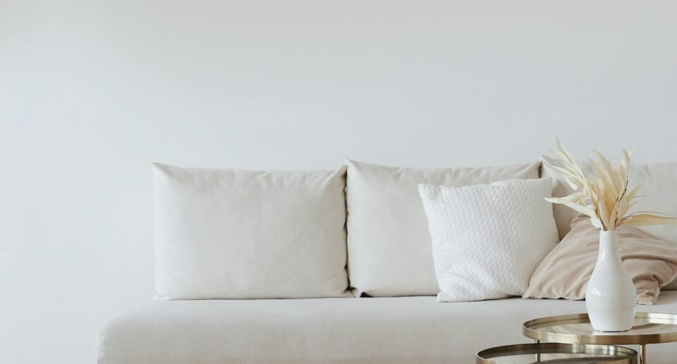 Cozy home interior with wooden furniture and large window showing monsoon rain outside